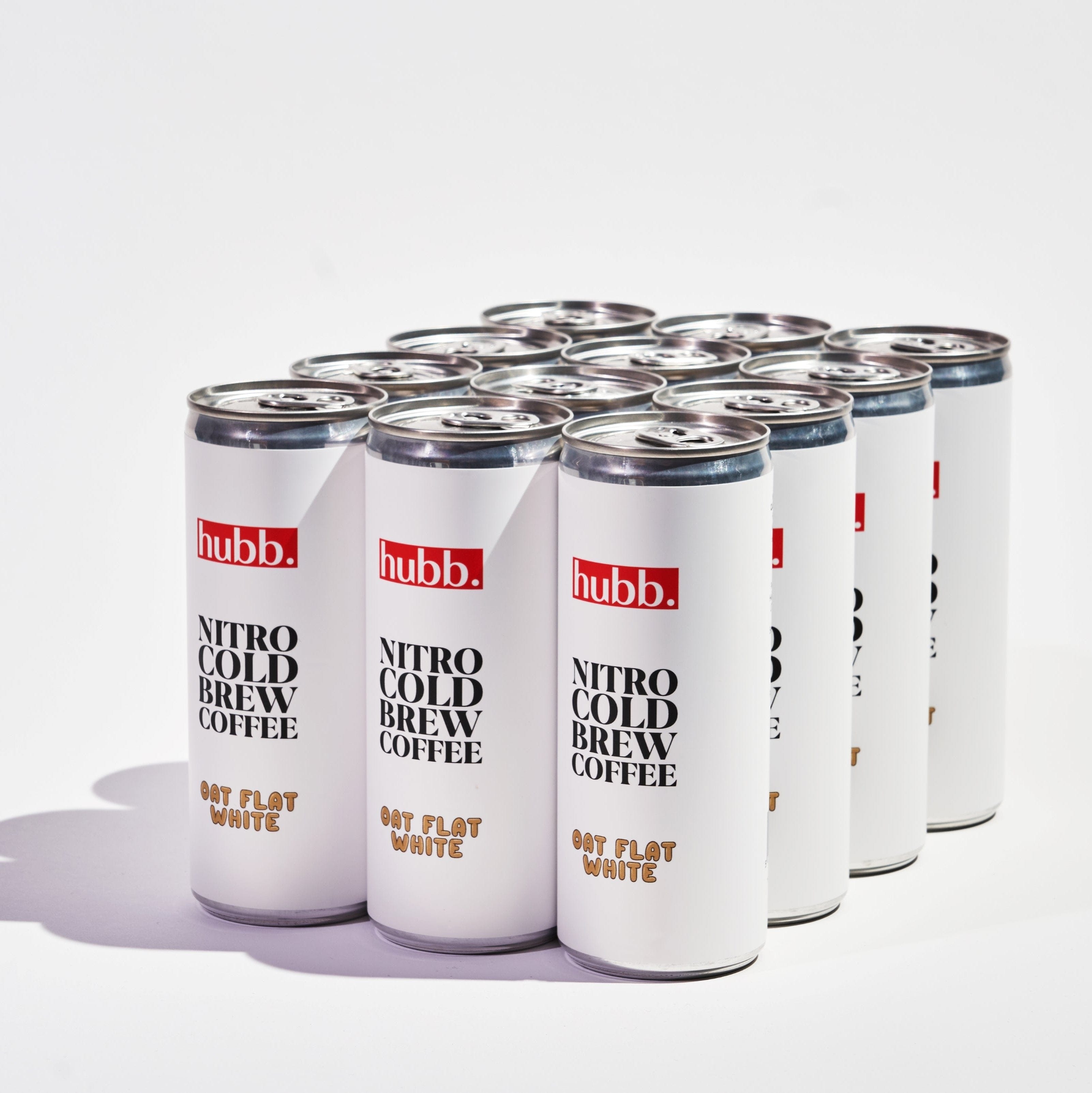 Twelve clean white cans of "hubb." Nitro Cold Brew Oat Flat White Coffee on a plain white background.